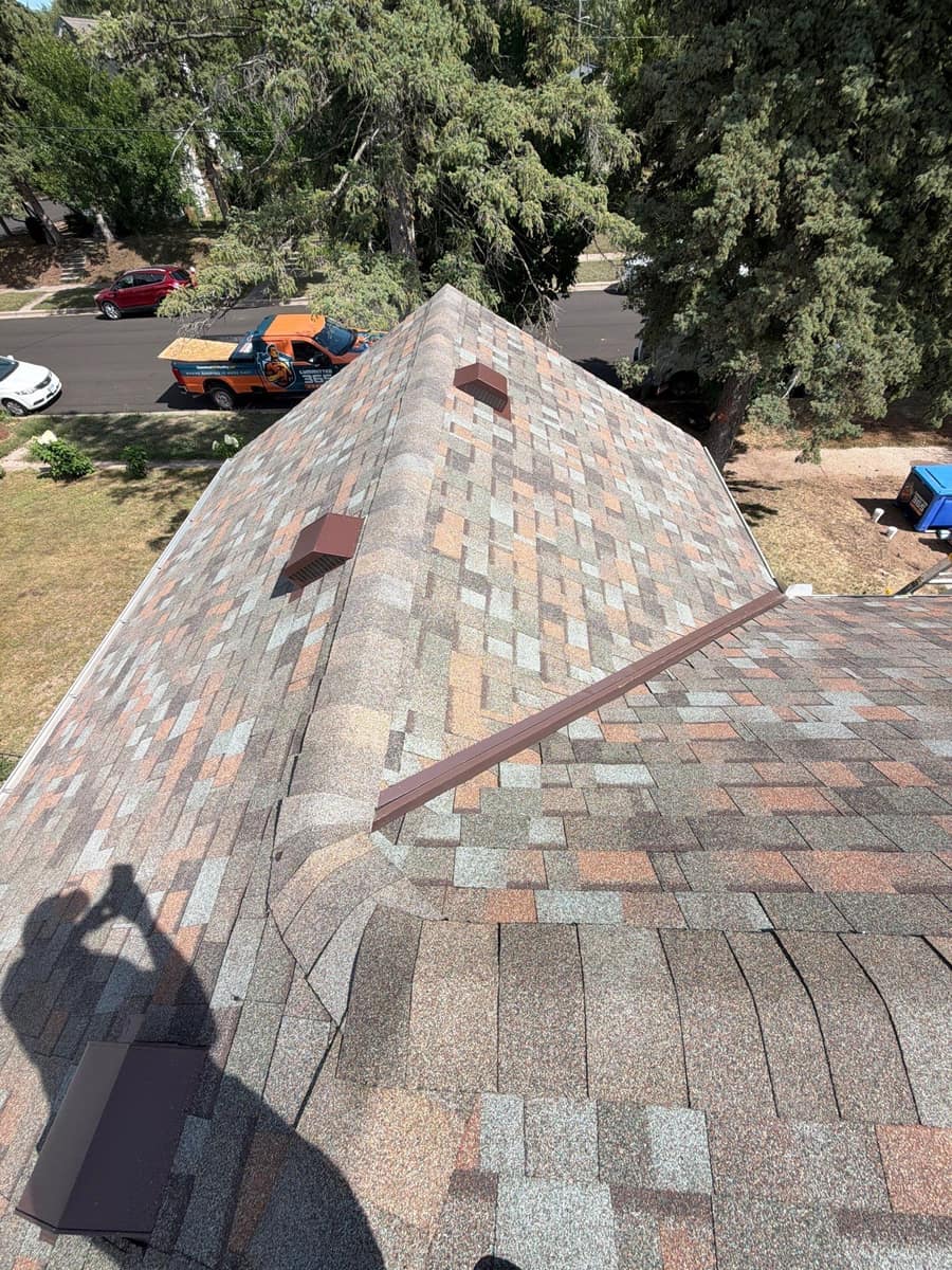 New shingle hip with brown roof vents on the St. Cloud home