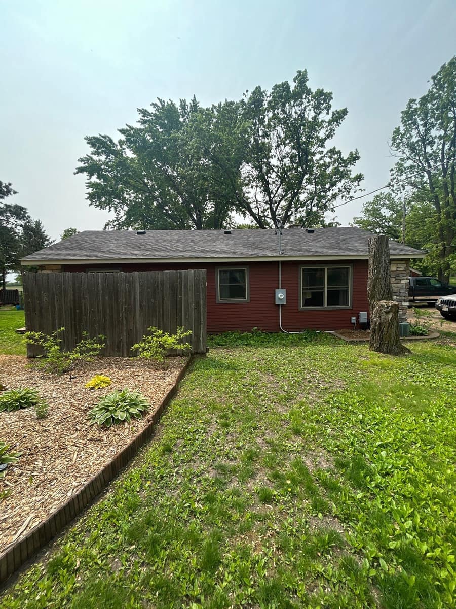 Single-story St. Cloud home with red siding and a new shingle roof