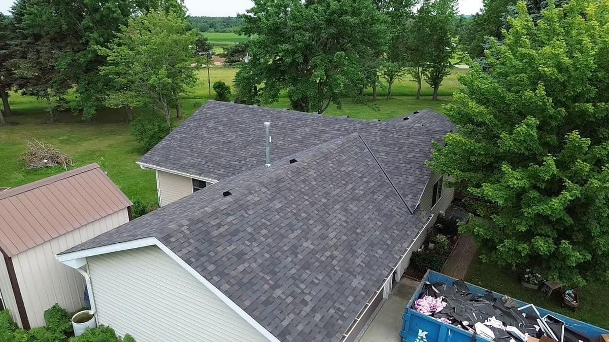 Drone view of a finished brown blend shingle roof on an L-shaped home near St. Cloud, MN