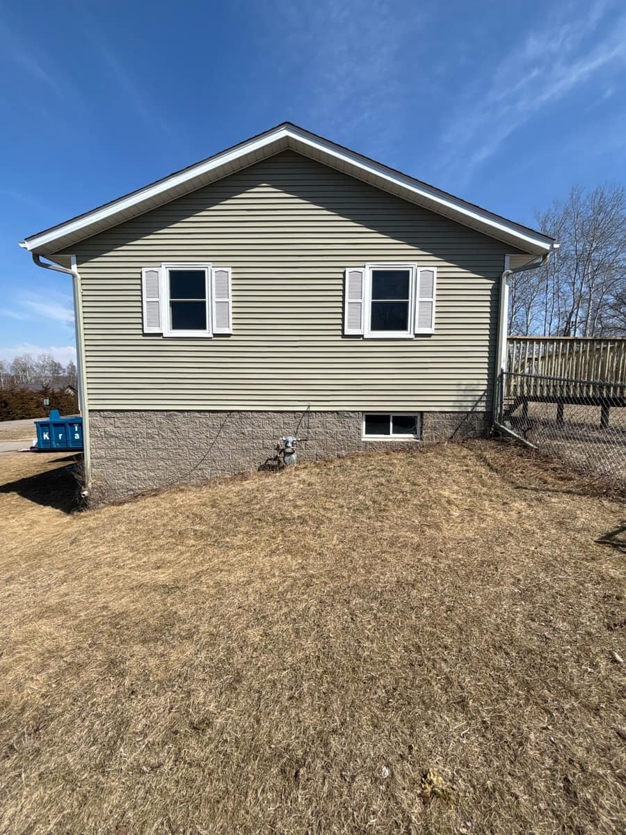 Gable end of the St. Joseph home with new sage green siding and white shutters