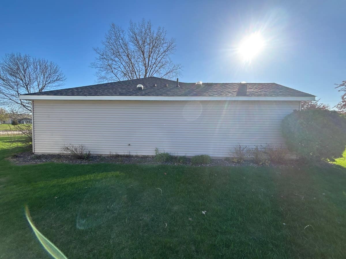 Side of the Waite Park home with tan siding under the new roof line