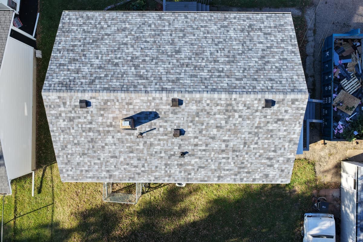 Overhead drone view of a new light gray shingle roof with vents on a Waite Park, MN home