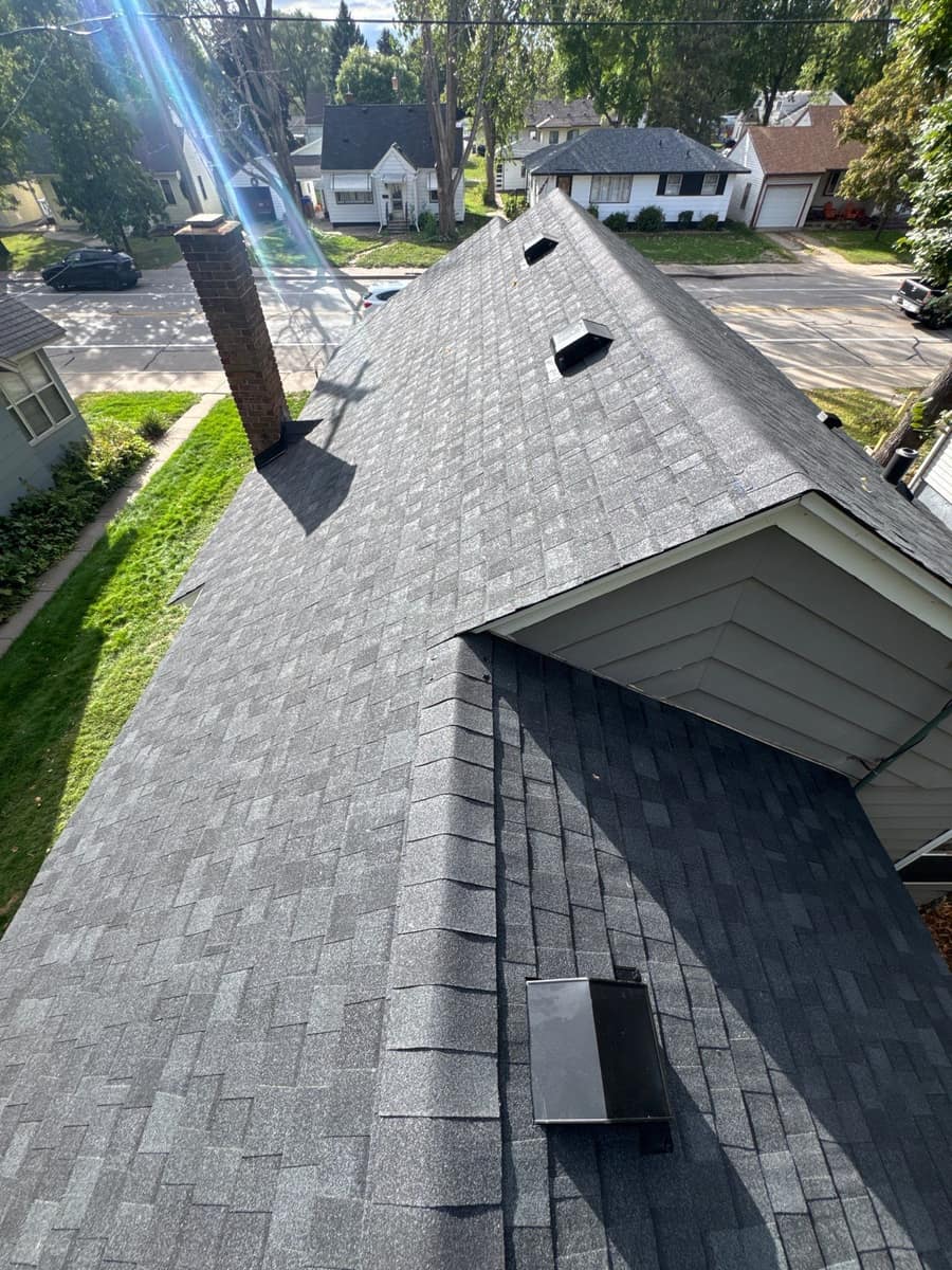 New shingles around a gable and roof vents on the Waite Park home