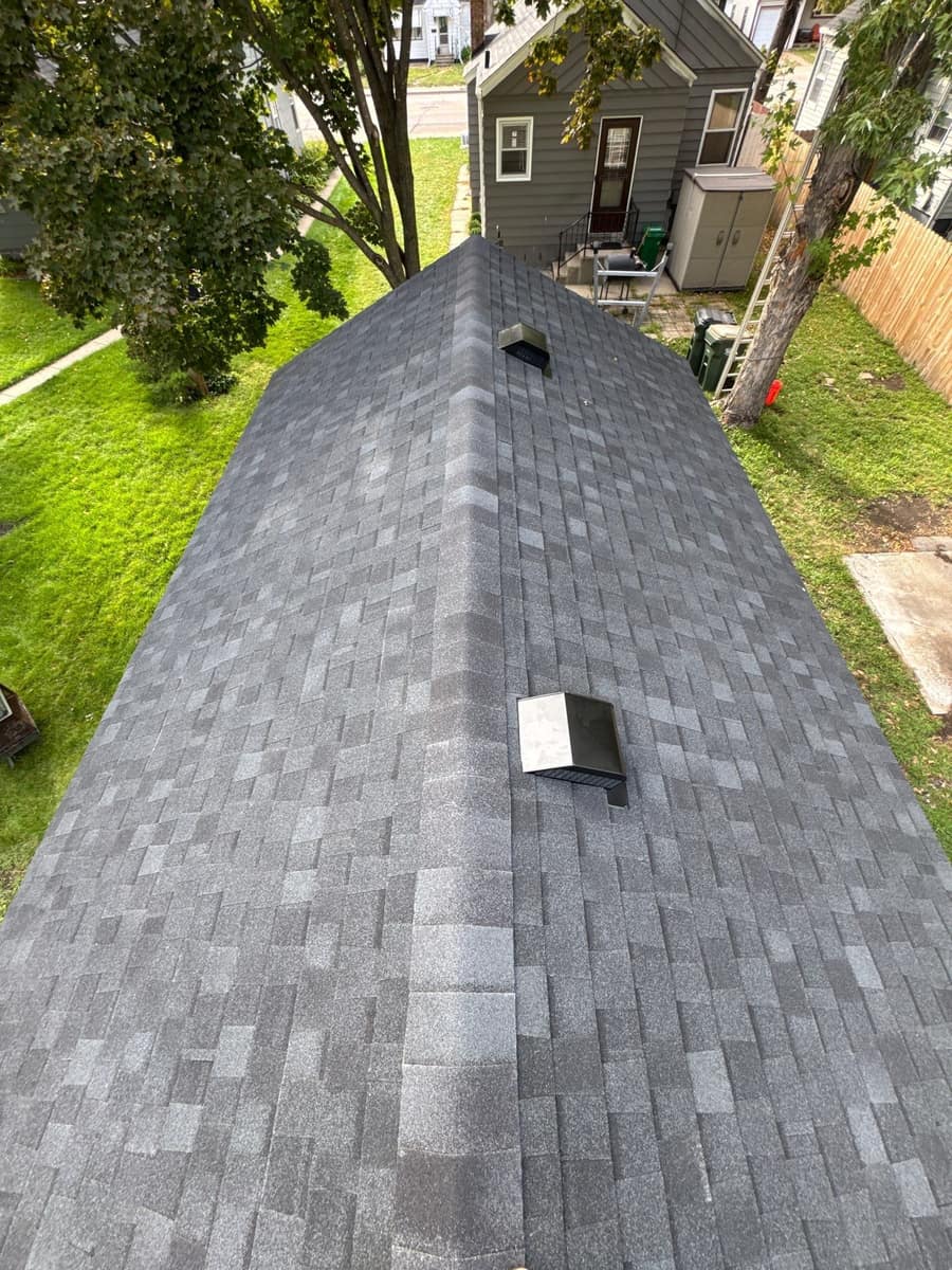 Long ridge of the new charcoal shingle roof in Waite Park