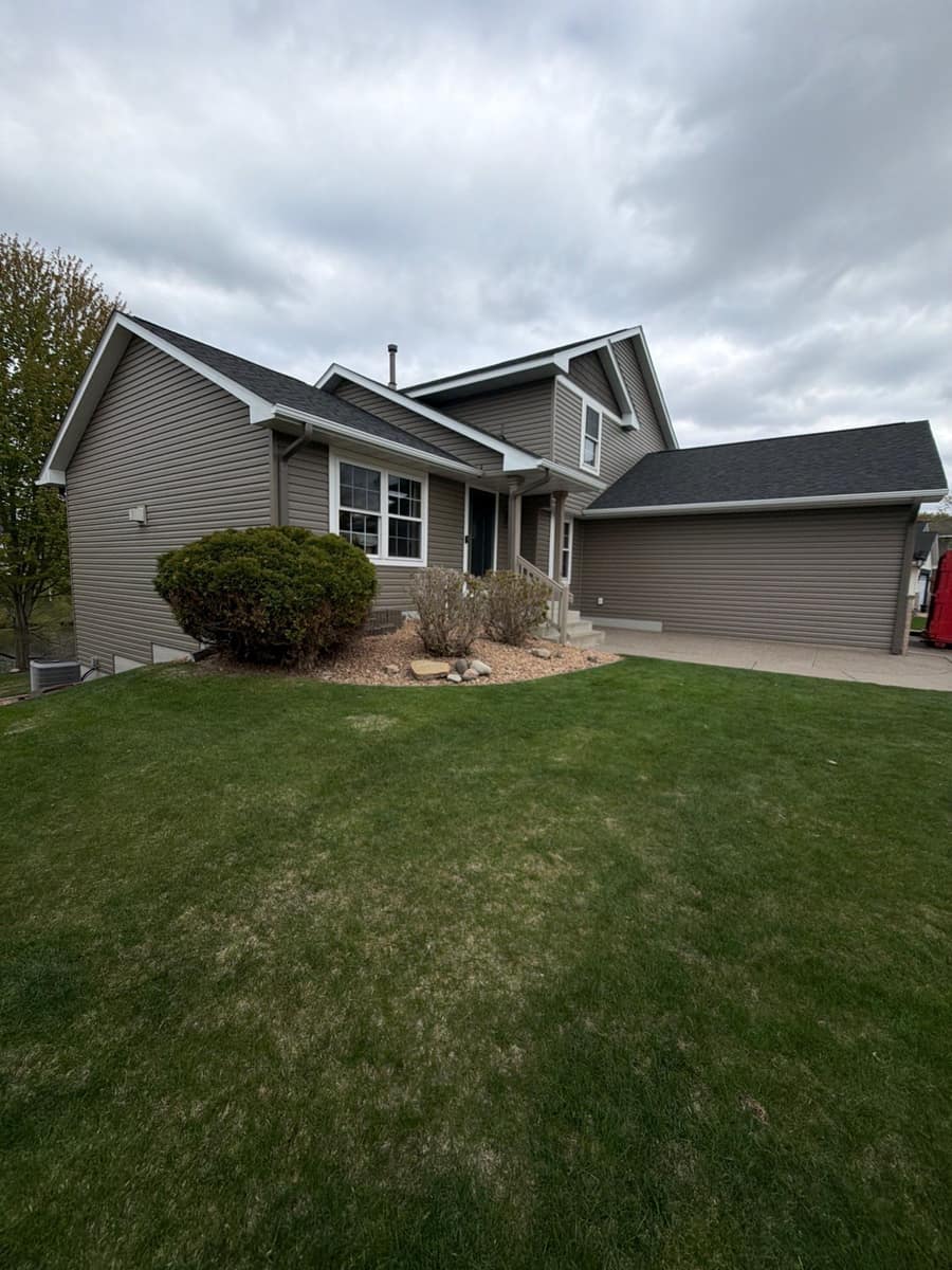 Two-story Woodbury, MN home with taupe siding and a new dark shingle roof