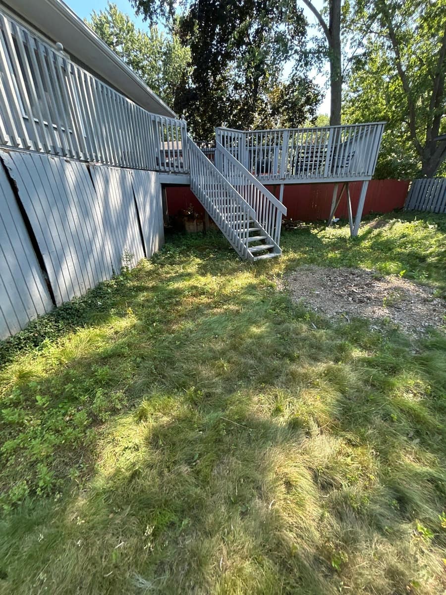 Back yard and deck stairs of the Woodbury home after the roof replacement
