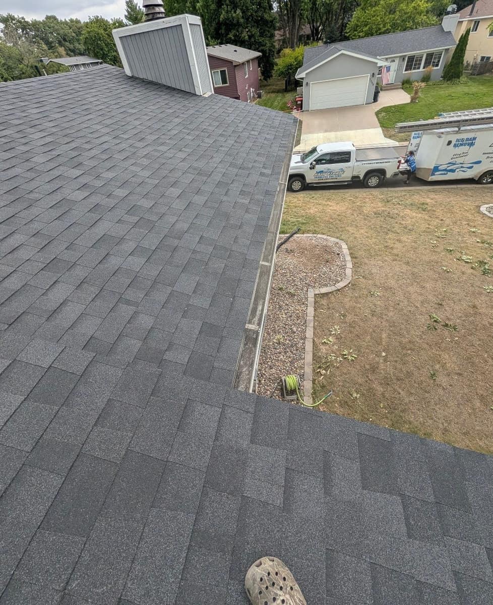 New charcoal shingles and chimney on the Woodbury roof above the front yard