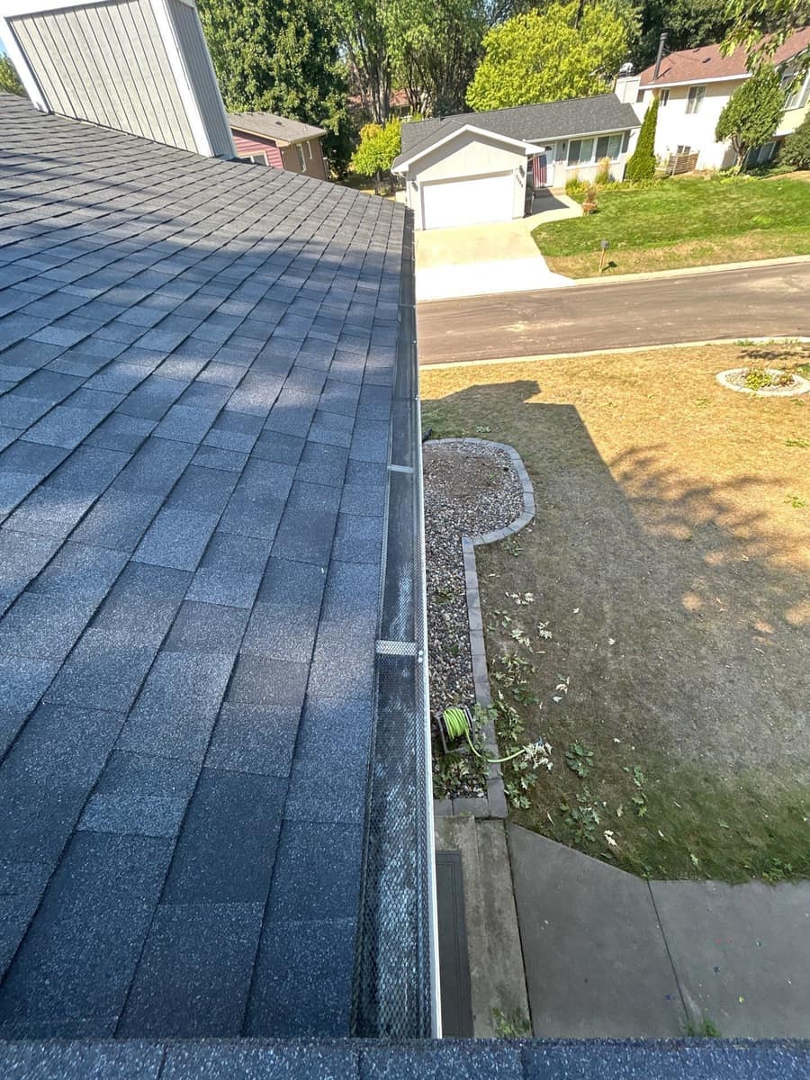 New shingles above a guarded gutter looking over the Woodbury street